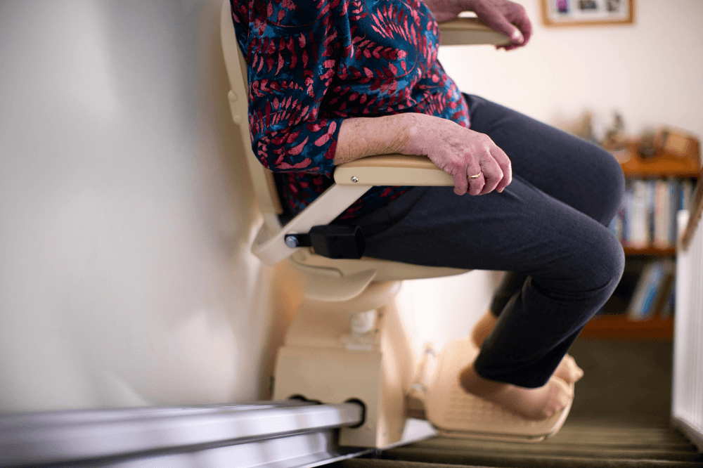 Woman Going Down a Stairlift